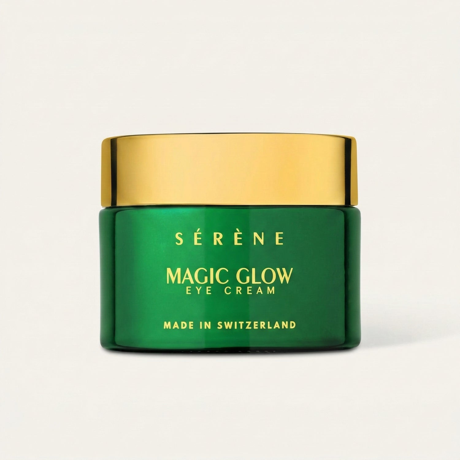 Green jar of Sérène Magic Glow Eye Cream with gold lid on a light beige background