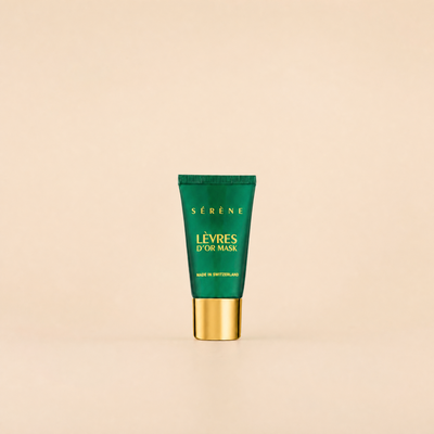 Green skincare mask tube with gold cap on a beige background